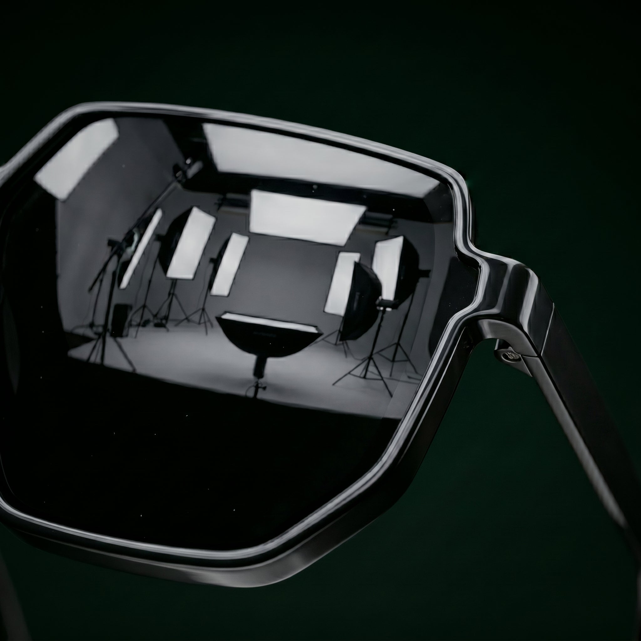 Reflective surface showing a photography studio setup with lights and equipment.