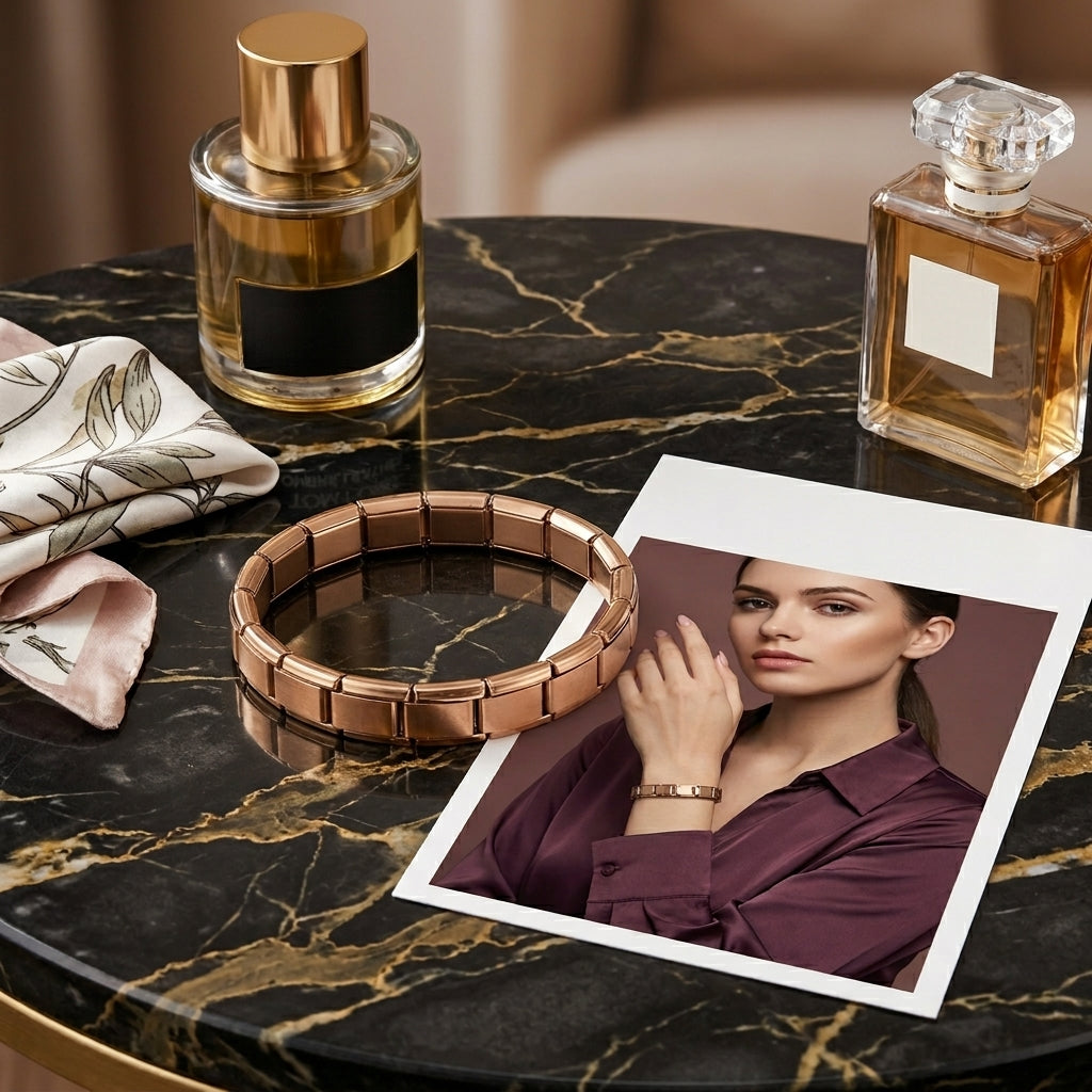 Two perfume bottles, a bracelet, and a photo of a woman on a marble surface.