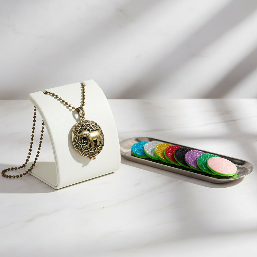 Gold elephant pendant necklace with colorful sample discs on a white background