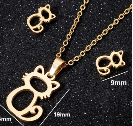 Gold cat-shaped necklace and earrings jewelry set on black background