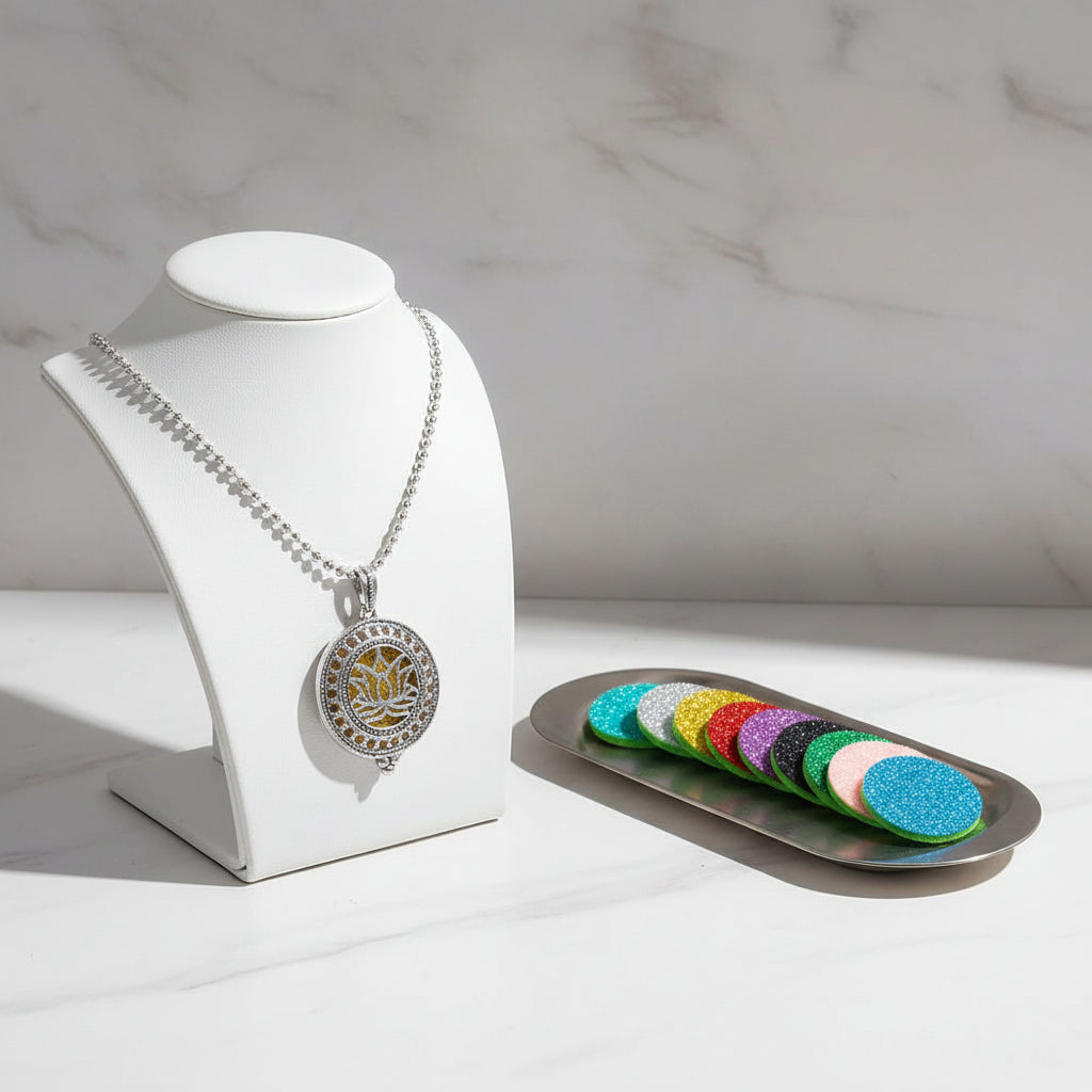 Decorative necklace with a lotus flower design and colorful refills on a white background
