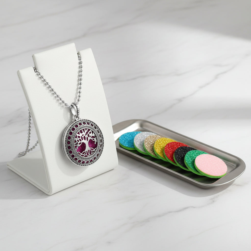Tree of Life pendant necklace with colorful scent pads on a white background